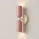 5lamp Capsule Pembe Krem çift yönlü metal duvar apliği, pembe gövde ve krem rozetle sıcak ışık yayılımıyla